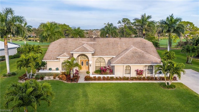 mediterranean / spanish-style house featuring a front yard