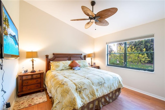 bedroom featuring vaulted ceiling, ceiling fan, and light wood-type flooring