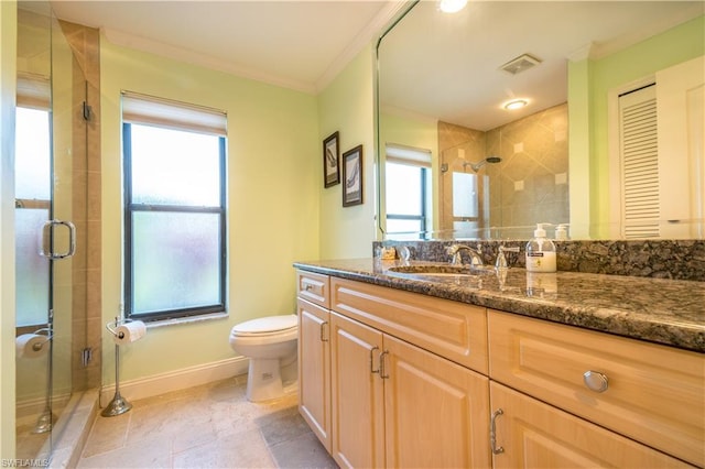 bathroom with an enclosed shower, tile flooring, vanity with extensive cabinet space, toilet, and crown molding