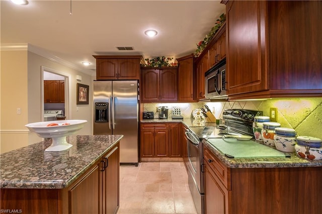 kitchen with light tile floors, appliances with stainless steel finishes, tasteful backsplash, and dark stone countertops