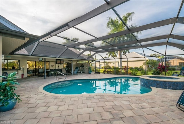 view of pool featuring a patio area, an in ground hot tub, and a lanai