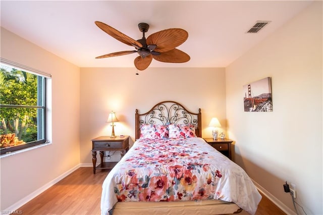 bedroom with light hardwood / wood-style flooring and ceiling fan