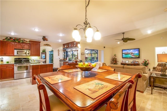 tiled dining space featuring vaulted ceiling and ceiling fan with notable chandelier