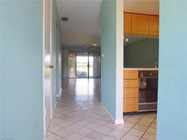 hallway featuring light tile floors