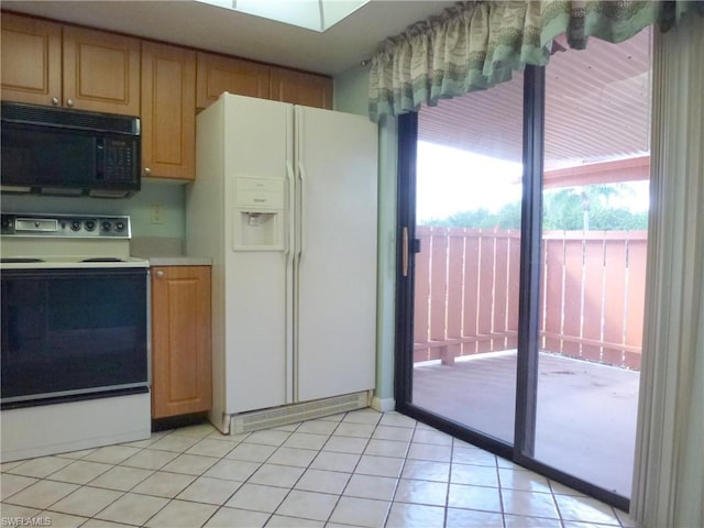 kitchen featuring light tile floors and white appliances