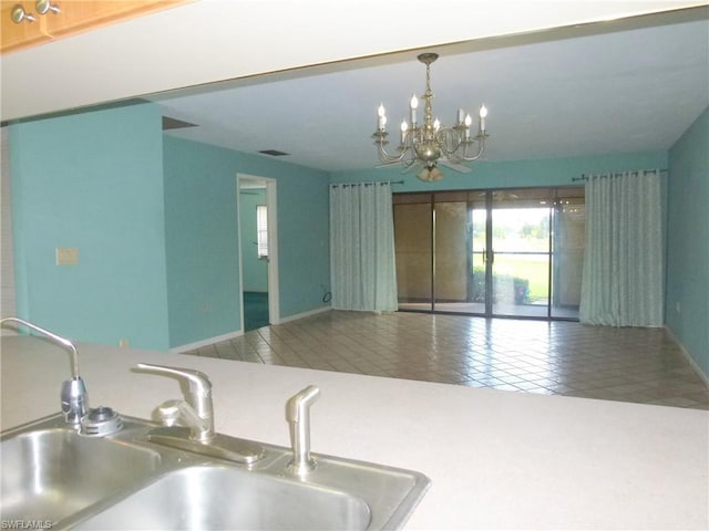 kitchen featuring decorative light fixtures, sink, a chandelier, and tile flooring