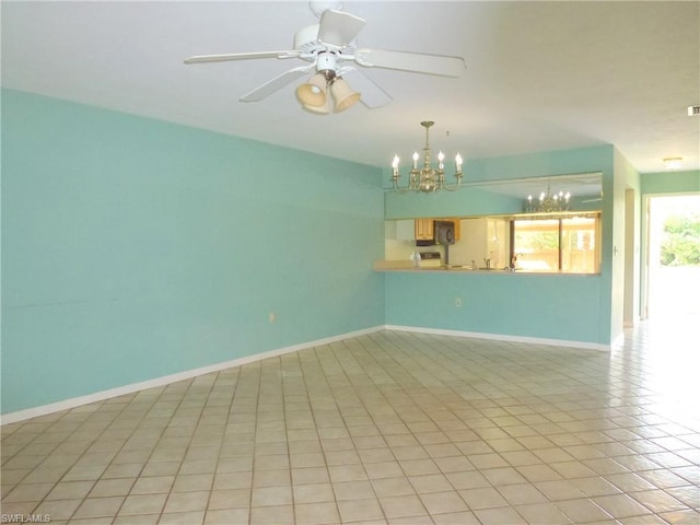 unfurnished living room featuring light tile flooring and ceiling fan with notable chandelier