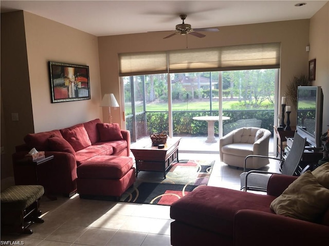 living room with dark tile flooring and ceiling fan