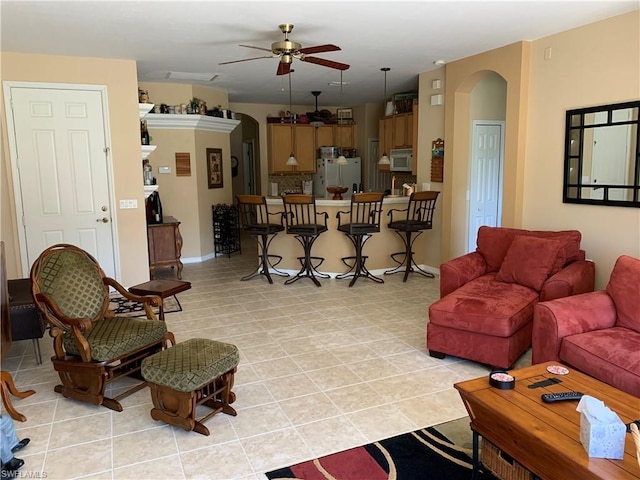 tiled living room with ceiling fan