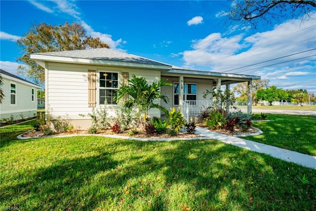 bungalow-style house with a front yard and covered porch