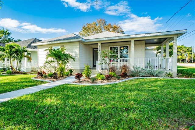 ranch-style home with a front lawn and a porch