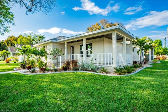 ranch-style house featuring a porch and a front yard