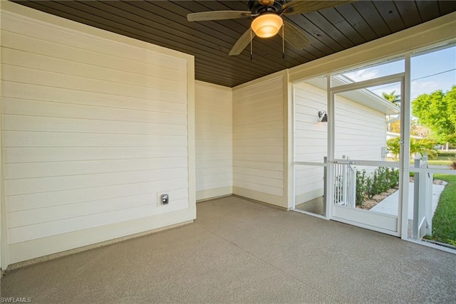 unfurnished sunroom with wooden ceiling, ceiling fan, and a healthy amount of sunlight