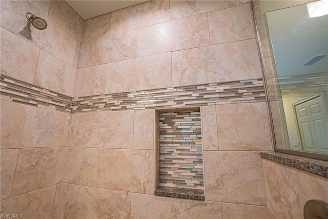 interior details featuring tiled shower