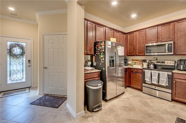 kitchen featuring light tile flooring, a healthy amount of sunlight, light stone countertops, and stainless steel appliances