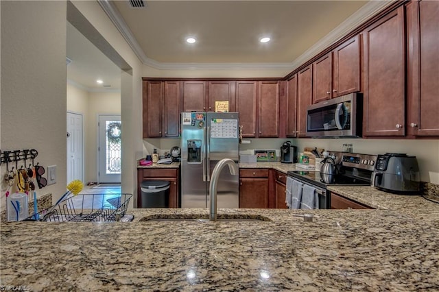 kitchen with crown molding, stainless steel appliances, and light stone counters