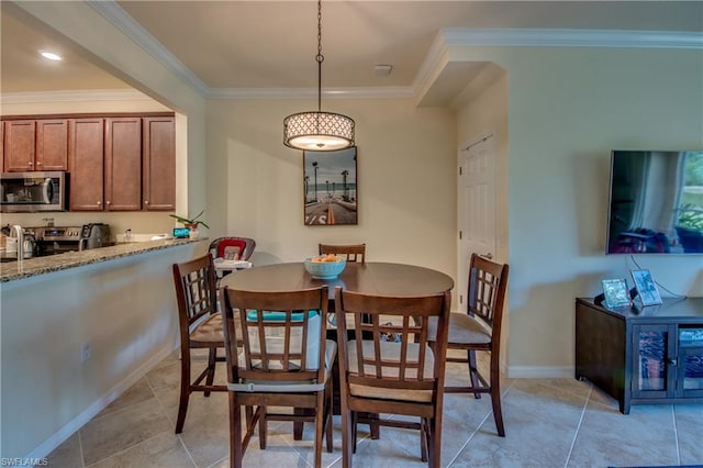 dining room with crown molding and light tile flooring