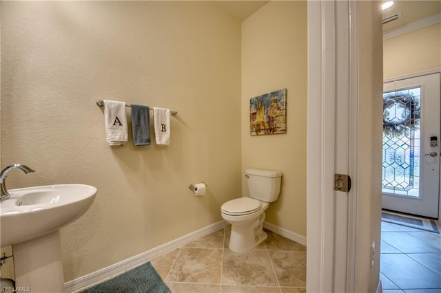 bathroom featuring toilet and tile floors