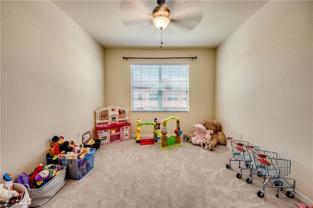 recreation room featuring light colored carpet and ceiling fan