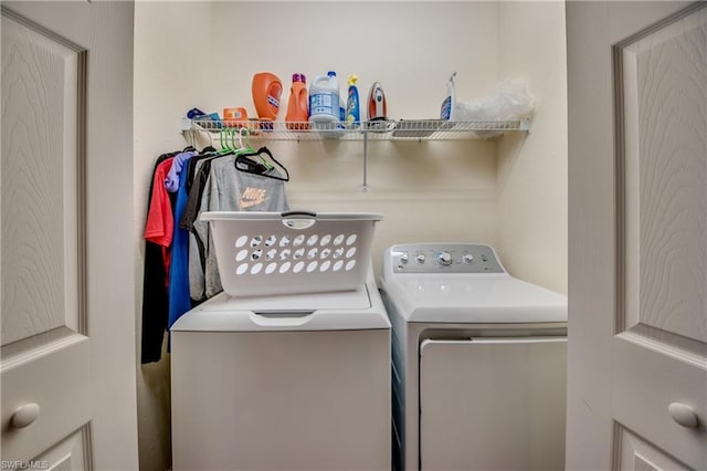 clothes washing area featuring independent washer and dryer