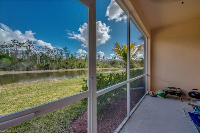 unfurnished sunroom with a water view