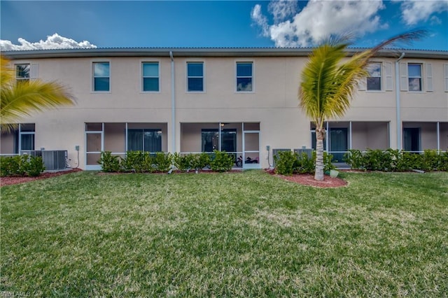 exterior space featuring a front lawn and central AC