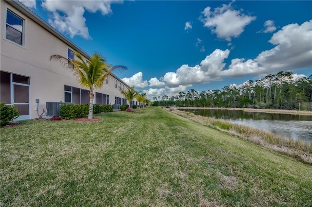 view of yard with a water view and central AC