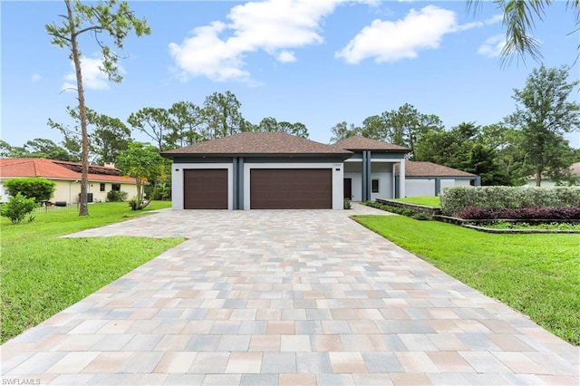 view of front of house with a front lawn and a garage