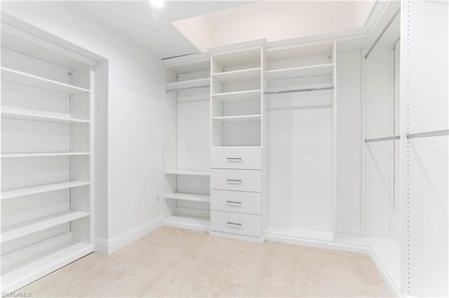 spacious closet with light tile floors