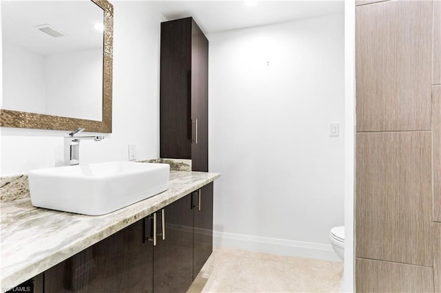 bathroom with vanity, tile flooring, and toilet