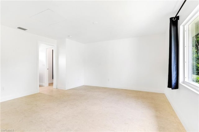 spare room with light tile floors