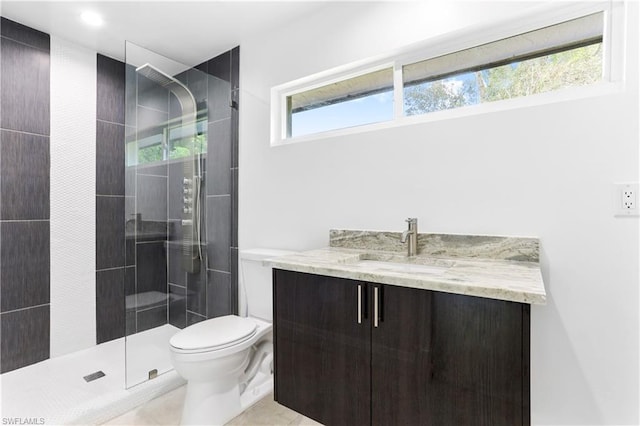 bathroom with vanity, tile floors, a shower with door, and toilet