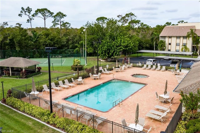 view of pool with a lawn and a patio area