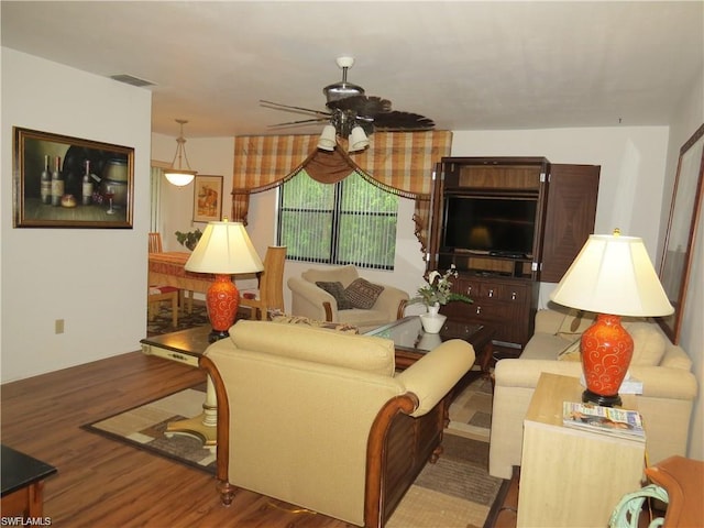 living room featuring hardwood / wood-style floors and ceiling fan