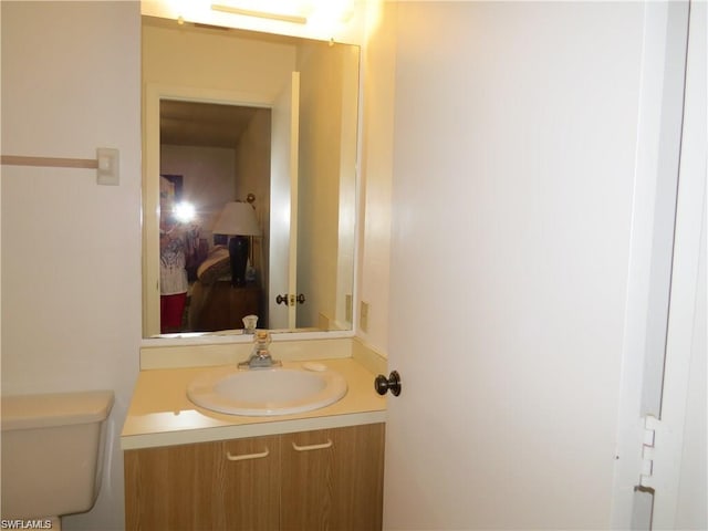 bathroom with toilet and vanity