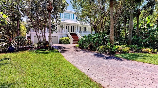 view of front of house with a front lawn and a garage