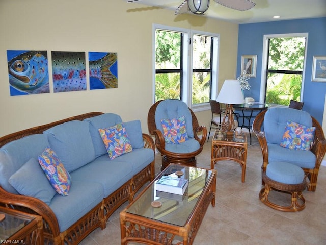 tiled living room with ceiling fan and a healthy amount of sunlight