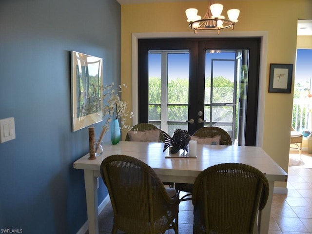 dining area with an inviting chandelier, french doors, and light tile floors