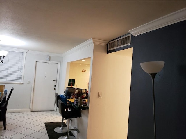 hall with light tile floors and crown molding