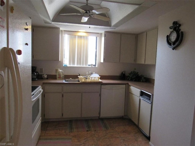 kitchen with white appliances, ceiling fan, and a tray ceiling