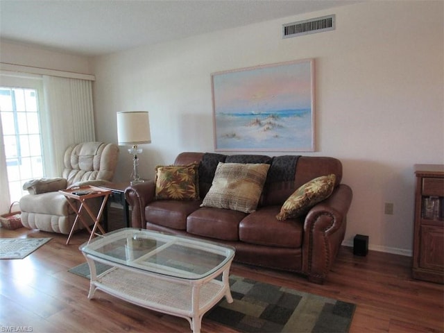 living room with dark hardwood / wood-style flooring