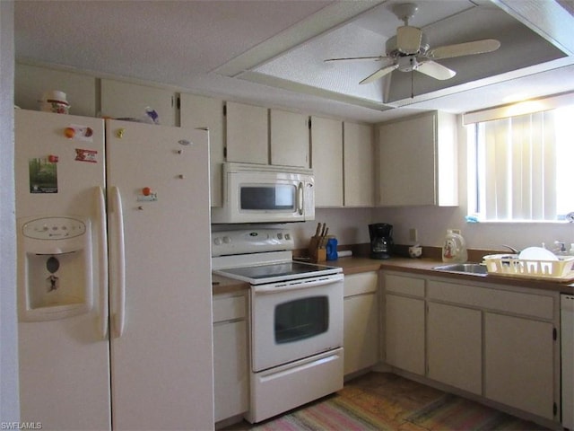 kitchen with ceiling fan, white appliances, and hardwood / wood-style flooring