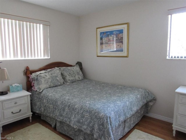 bedroom with dark hardwood / wood-style floors