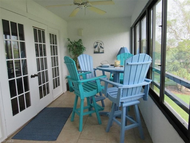 sunroom / solarium with plenty of natural light, french doors, and ceiling fan