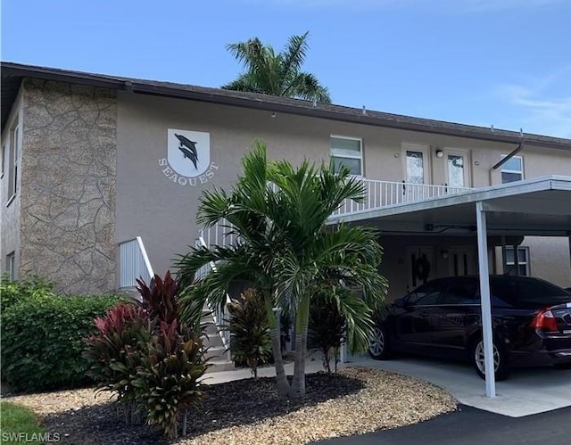 exterior space with a balcony and a carport