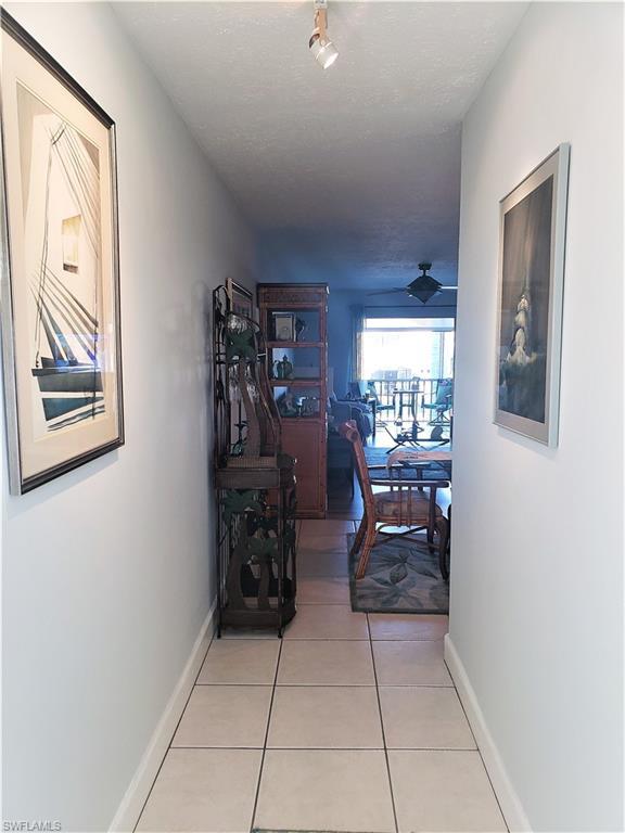 hallway featuring light tile floors