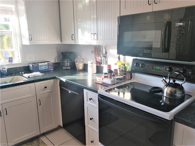 kitchen with sink, light tile floors, black appliances, and white cabinetry