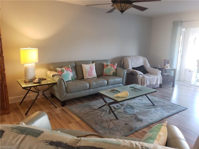 living room with ceiling fan and light wood-type flooring