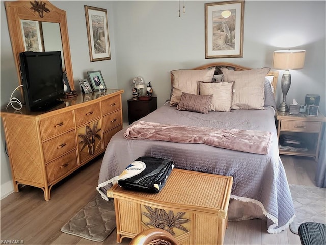 bedroom with hardwood / wood-style flooring