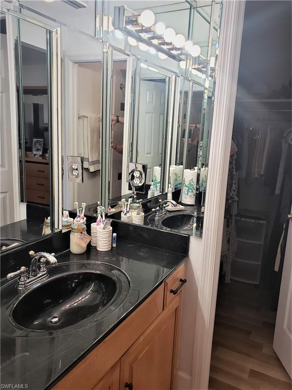 bathroom featuring hardwood / wood-style floors and oversized vanity